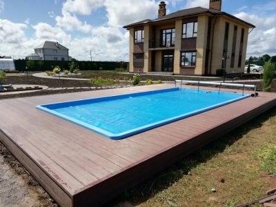 Прямоугольный композитный бассейн на террасе с декингом и домом